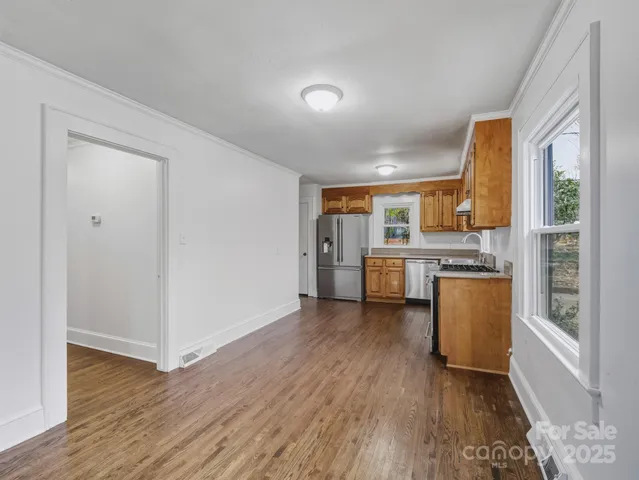 a view of a kitchen with a sink and a stove top oven