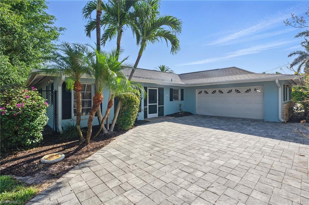261 Viking Way Naples, FL 34110 - Photo 1 of 40 a front view of a house with yard and trees