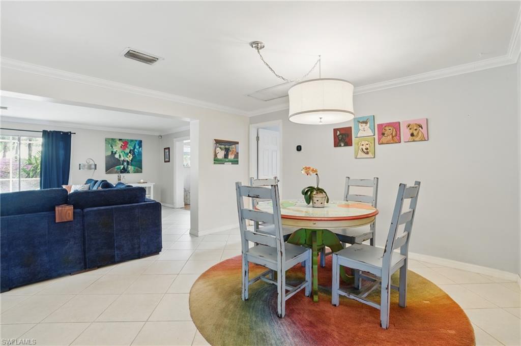 261 Viking Way Naples, FL 34110 - Photo 11 of 40 a living room with furniture and a dining table