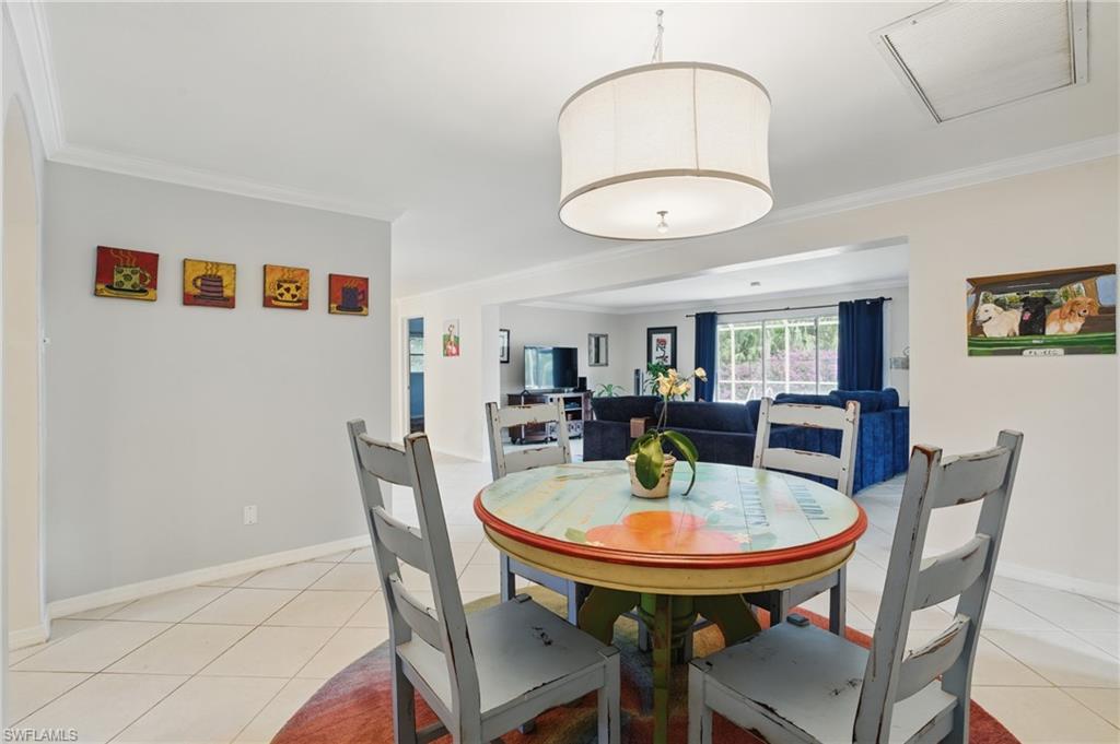 261 Viking Way Naples, FL 34110 - Photo 12 of 40 a view of a dining room with furniture and wooden floor