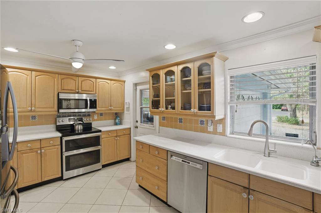 261 Viking Way Naples, FL 34110 - Photo 13 of 40 a kitchen with a sink stainless steel appliances and cabinets