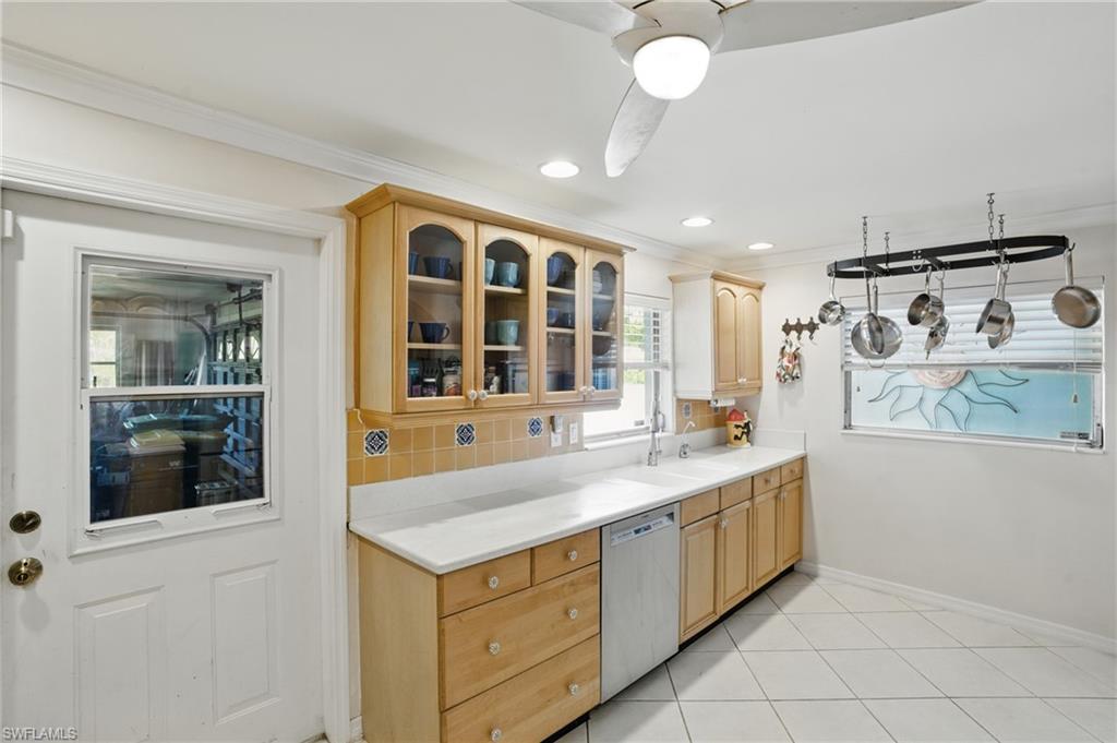 261 Viking Way Naples, FL 34110 - Photo 16 of 40 a kitchen with a sink and a refrigerator
