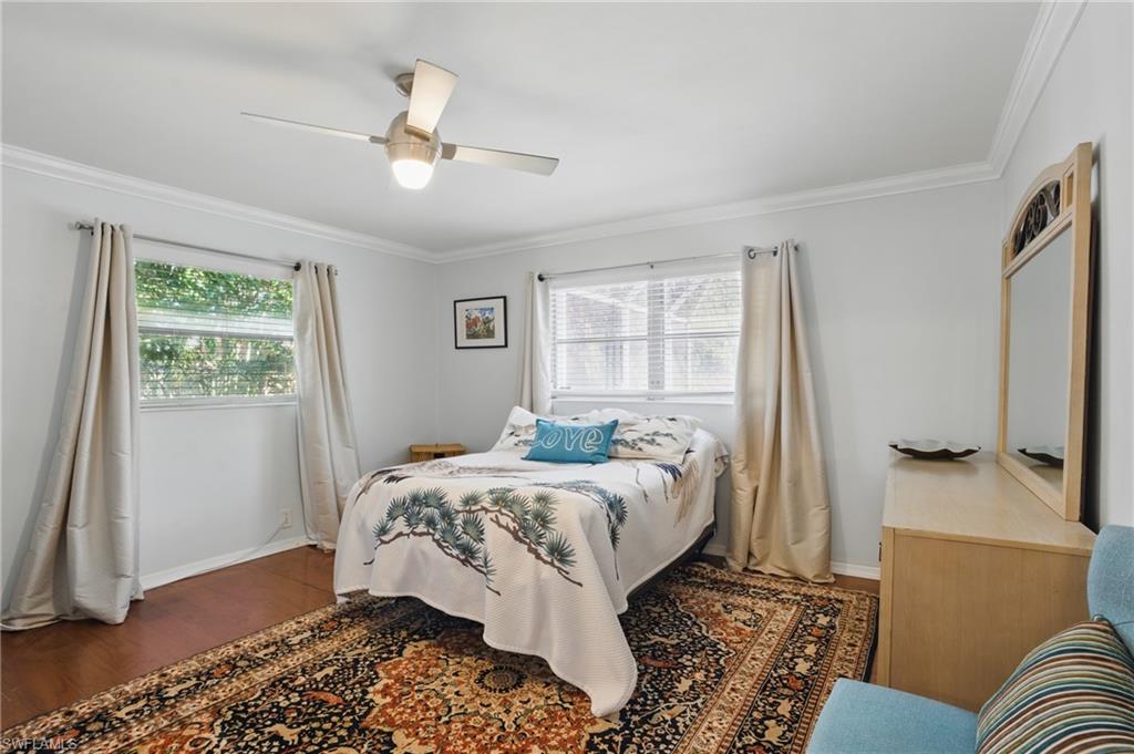 261 Viking Way Naples, FL 34110 - Photo 17 of 40 a bed sitting in a bedroom next to a window