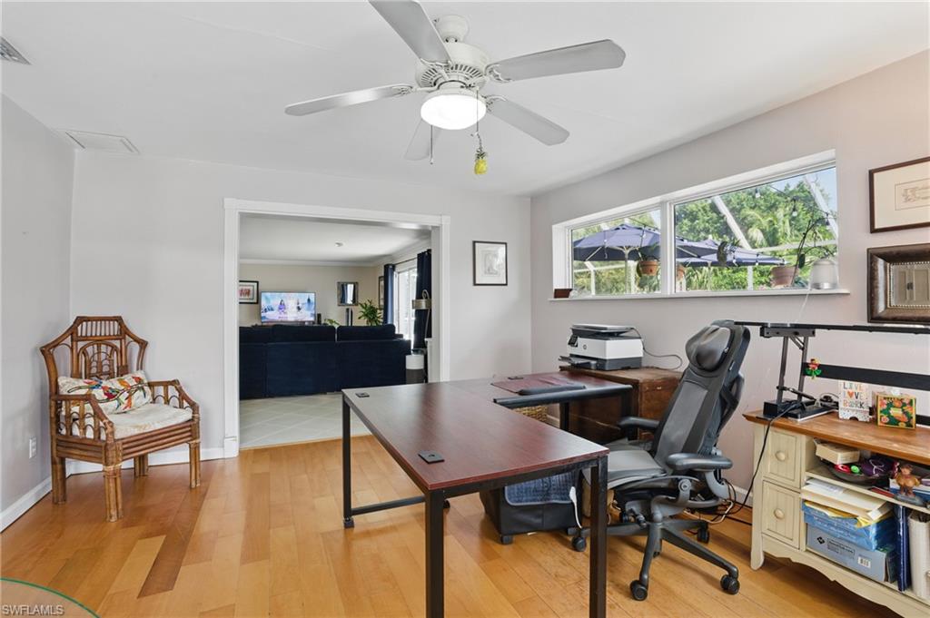 261 Viking Way Naples, FL 34110 - Photo 22 of 40 a view of a workspace with furniture and a large window