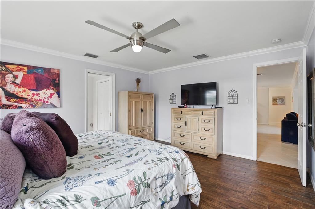 261 Viking Way Naples, FL 34110 - Photo 24 of 40 a bedroom with a bed and a flat screen tv