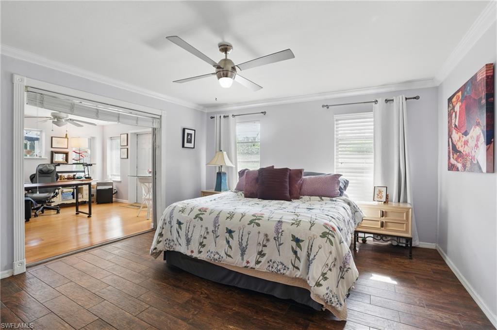 261 Viking Way Naples, FL 34110 - Photo 25 of 40 a bedroom with a bed and a chandelier