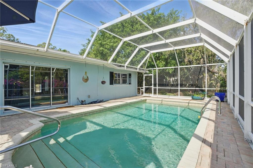 261 Viking Way Naples, FL 34110 - Photo 29 of 40 a view of a backyard with a swimming pool