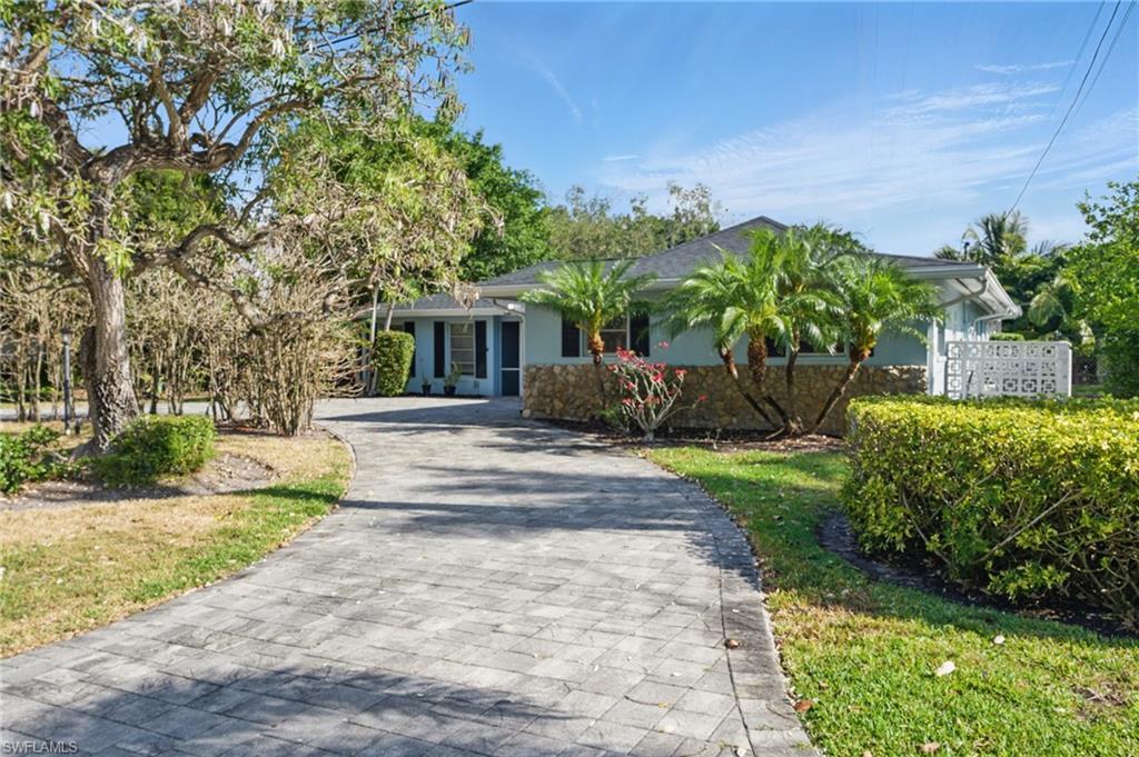 261 Viking Way Naples, FL 34110 - Photo 3 of 40 a front view of a house with garden