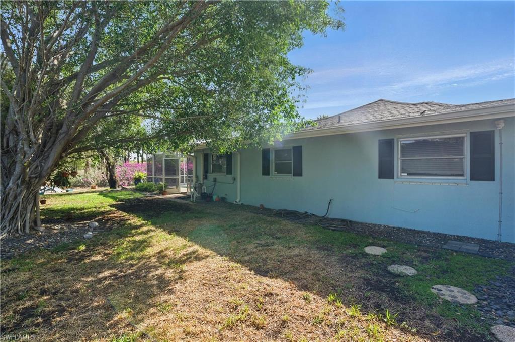 261 Viking Way Naples, FL 34110 - Photo 35 of 40 a backyard of a house with lots of green space