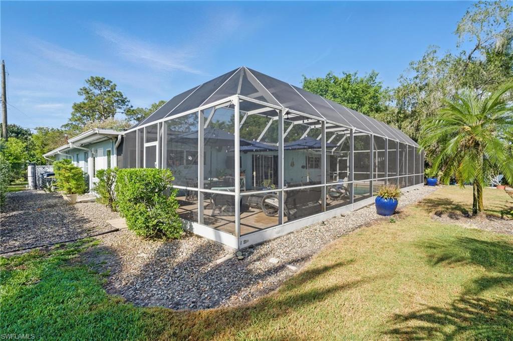 261 Viking Way Naples, FL 34110 - Photo 37 of 40 a view of a house with backyard and sitting area