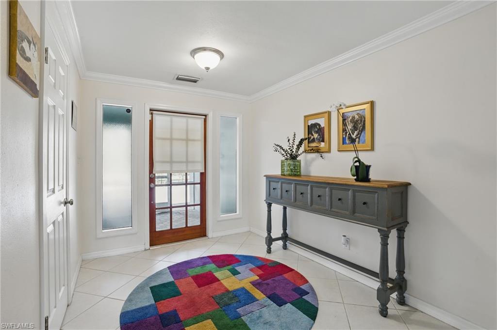 261 Viking Way Naples, FL 34110 - Photo 5 of 40 a bedroom with a bed and a window