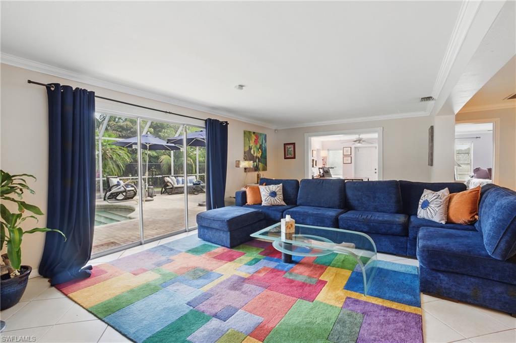 261 Viking Way Naples, FL 34110 - Photo 7 of 40 a living room with furniture and a floor to ceiling window
