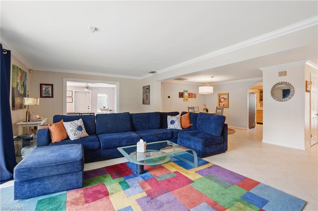 261 Viking Way Naples, FL 34110 - Photo 8 of 40 a living room with furniture and a couch