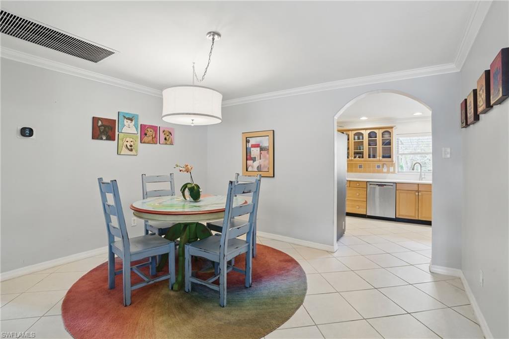 261 Viking Way Naples, FL 34110 - Photo 9 of 40 a view of a dining room with furniture and wooden floor