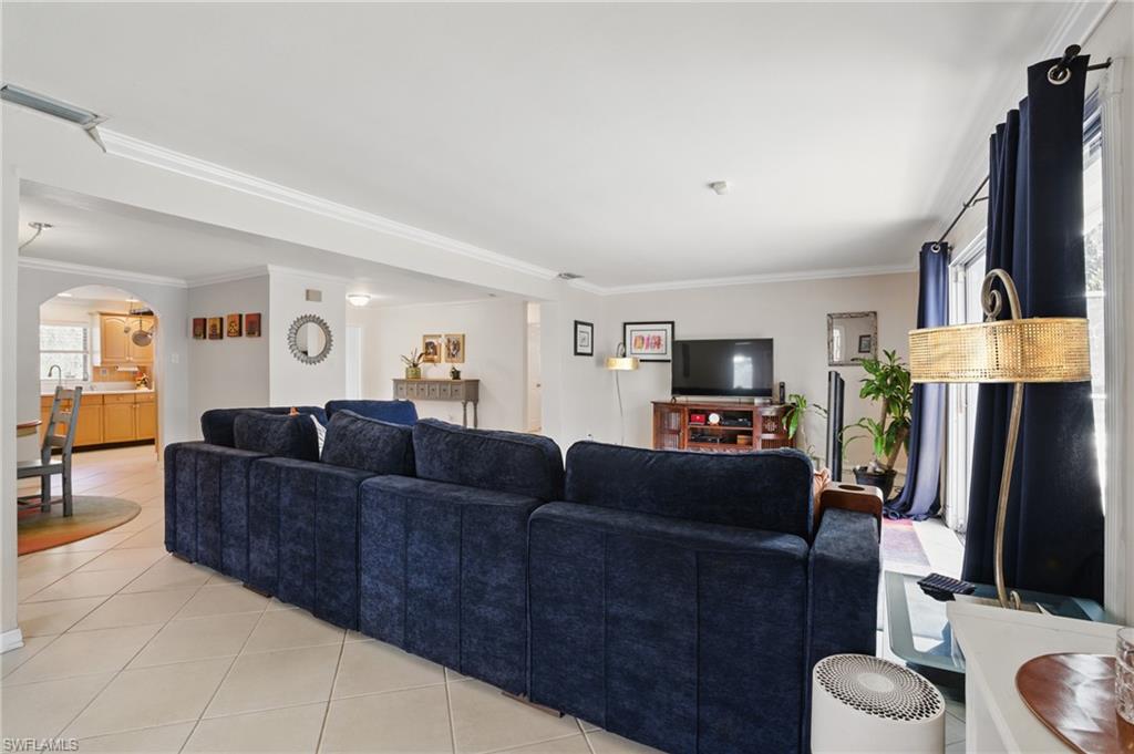 261 Viking Way Naples, FL 34110 - Photo 10 of 40 a living room with furniture and a flat screen tv