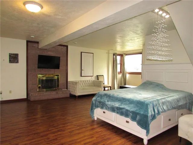 a bedroom with a bed and a flat tv screen