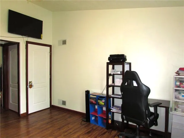 a view of a workspace with furniture and wooden floor