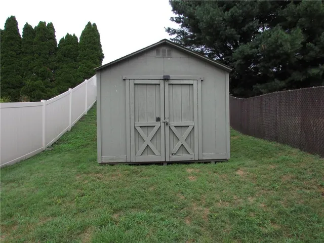 a view of backyard of house with green space