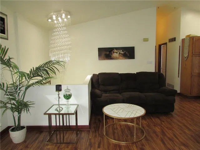 a living room with furniture and a chandelier