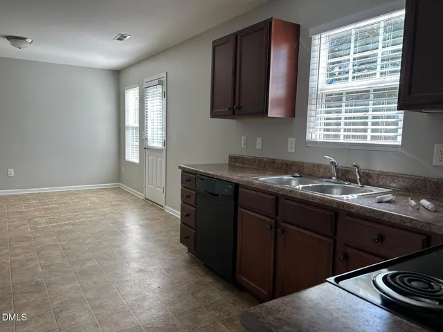 a kitchen with a sink stove and cabinets