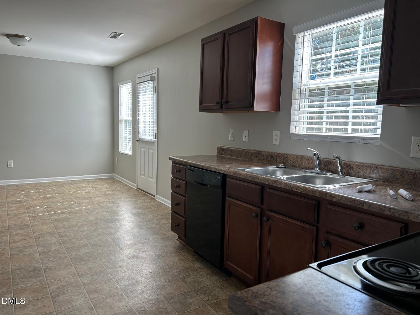 1524 Ricochet Drive Raleigh, NC 27610 - Photo 4 of 17 a kitchen with a sink stove and cabinets