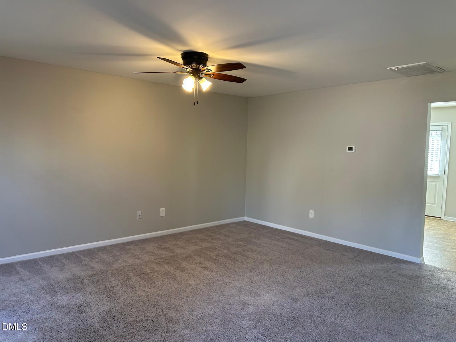 1524 Ricochet Drive Raleigh, NC 27610 - Photo 5 of 17 a view of an empty room with a window