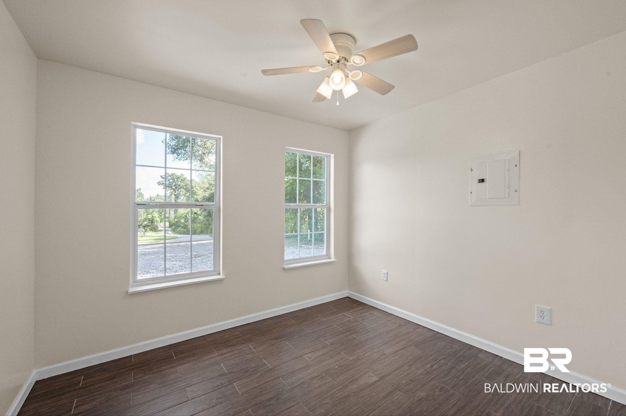 20037 County Road 33 Fairhope, AL 36532 - Photo 53 of 79 Unfurnished room featuring dark hardwood / wood-style floors, electric panel, and ceiling fan