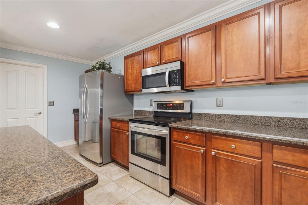 25134 Palisade Road Punta Gorda, FL 33983 - Photo 23 of 58 a kitchen with stainless steel appliances granite countertop a stove a sink and a microwave