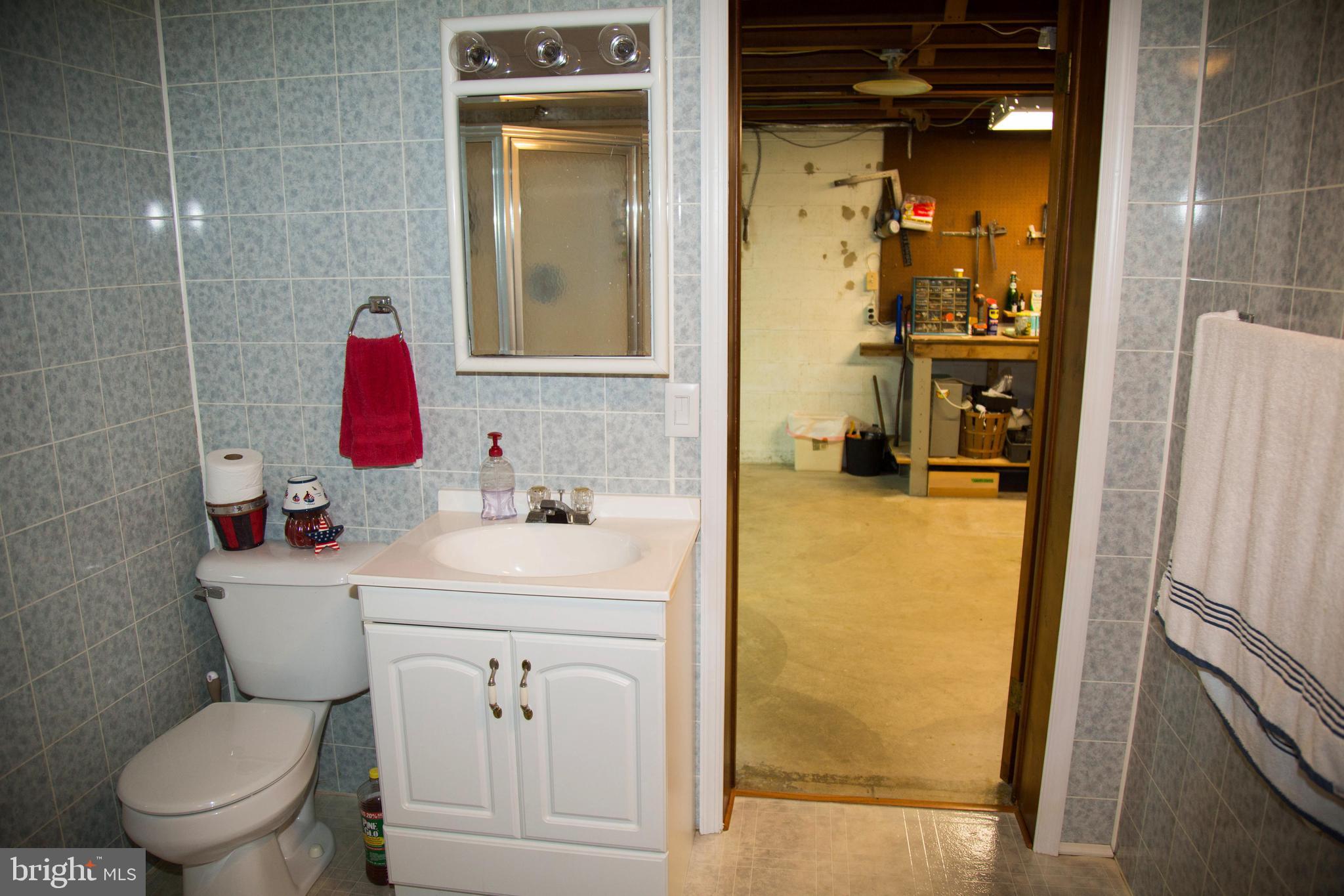 1722 Severn Road Severn, MD 21144 - Photo 43 of 45 a bathroom with a sink toilet vanity and shower