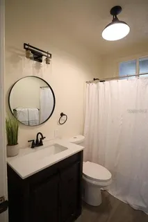 a bathroom with a sink vanity mirror and toilet