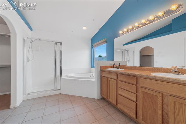 12576 Snaffle Bit Road Peyton, CO 80831 - Photo 11 of 37 5 Peice bath adjoins the primary bedroom.