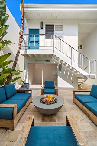 a living room with furniture a fireplace and a floor to ceiling window