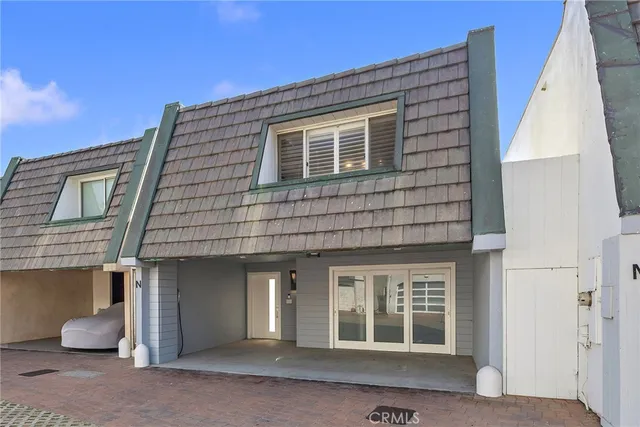 a bedroom with two beds and a chair