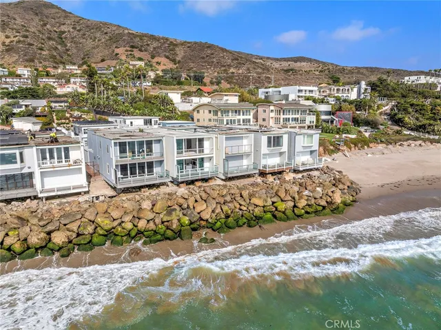 a bathroom with a toilet a sink a mirror and a shower