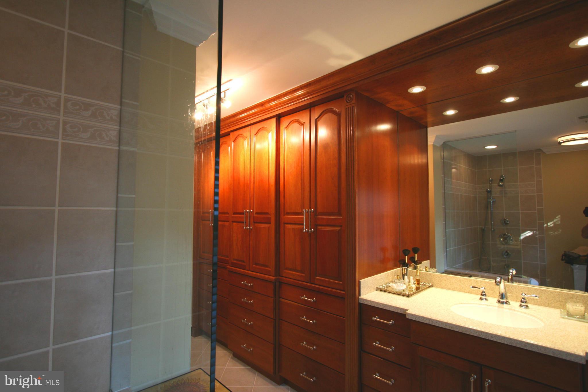 11939 Riders Lane Reston, VA 20191 - Photo 11 of 30 a bathroom with a double vanity sink and a mirror