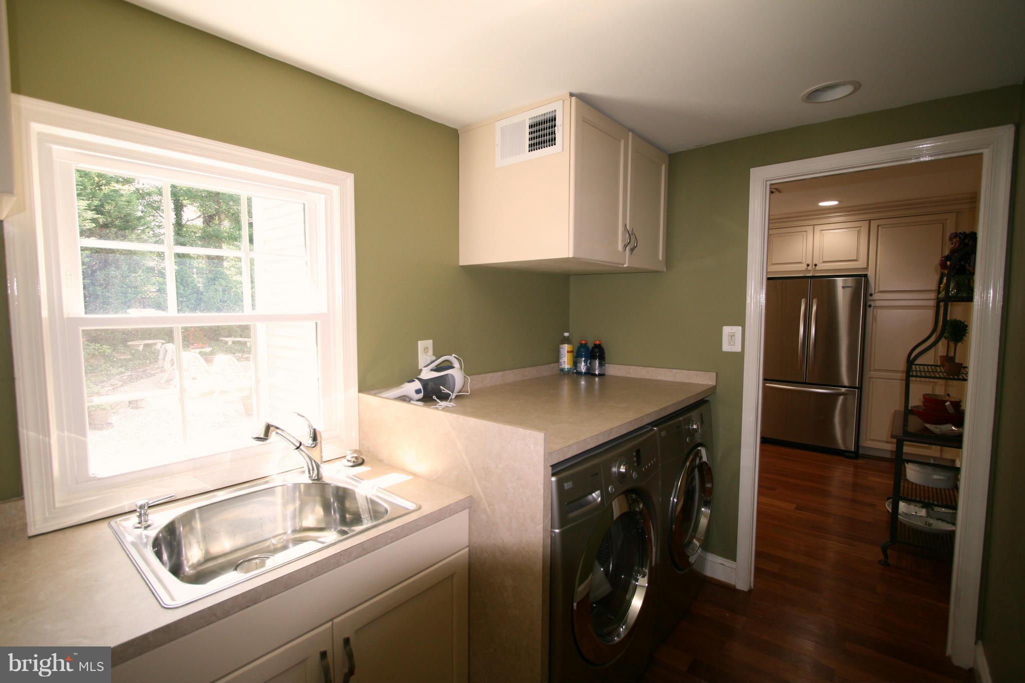 11939 Riders Lane Reston, VA 20191 - Photo 21 of 30 a kitchen with a sink cabinets and stainless steel appliances