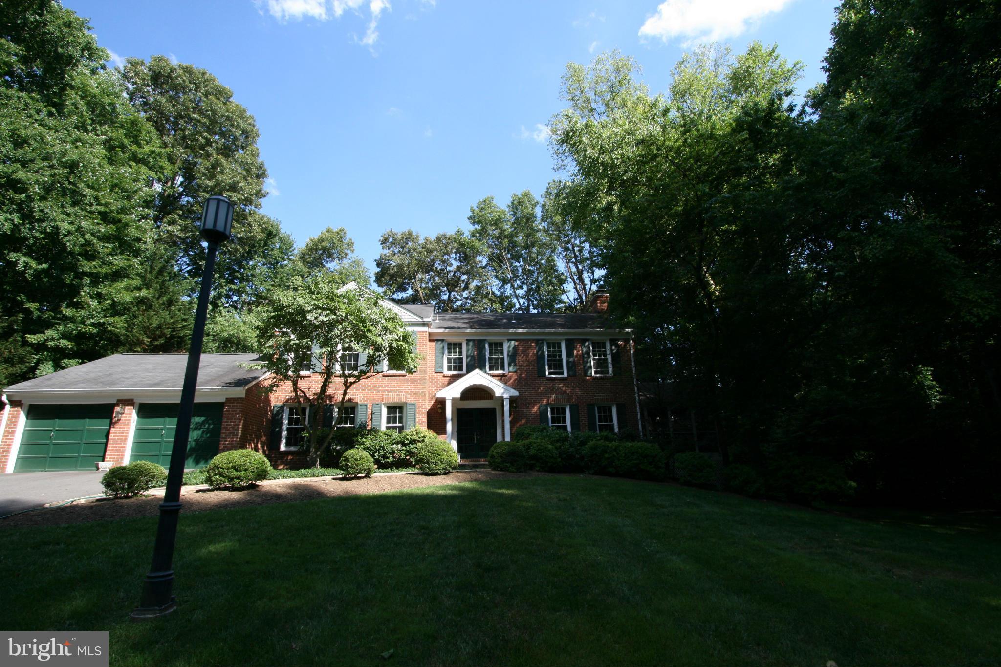 11939 Riders Lane Reston, VA 20191 - Photo 23 of 30 a front view of a house with garden