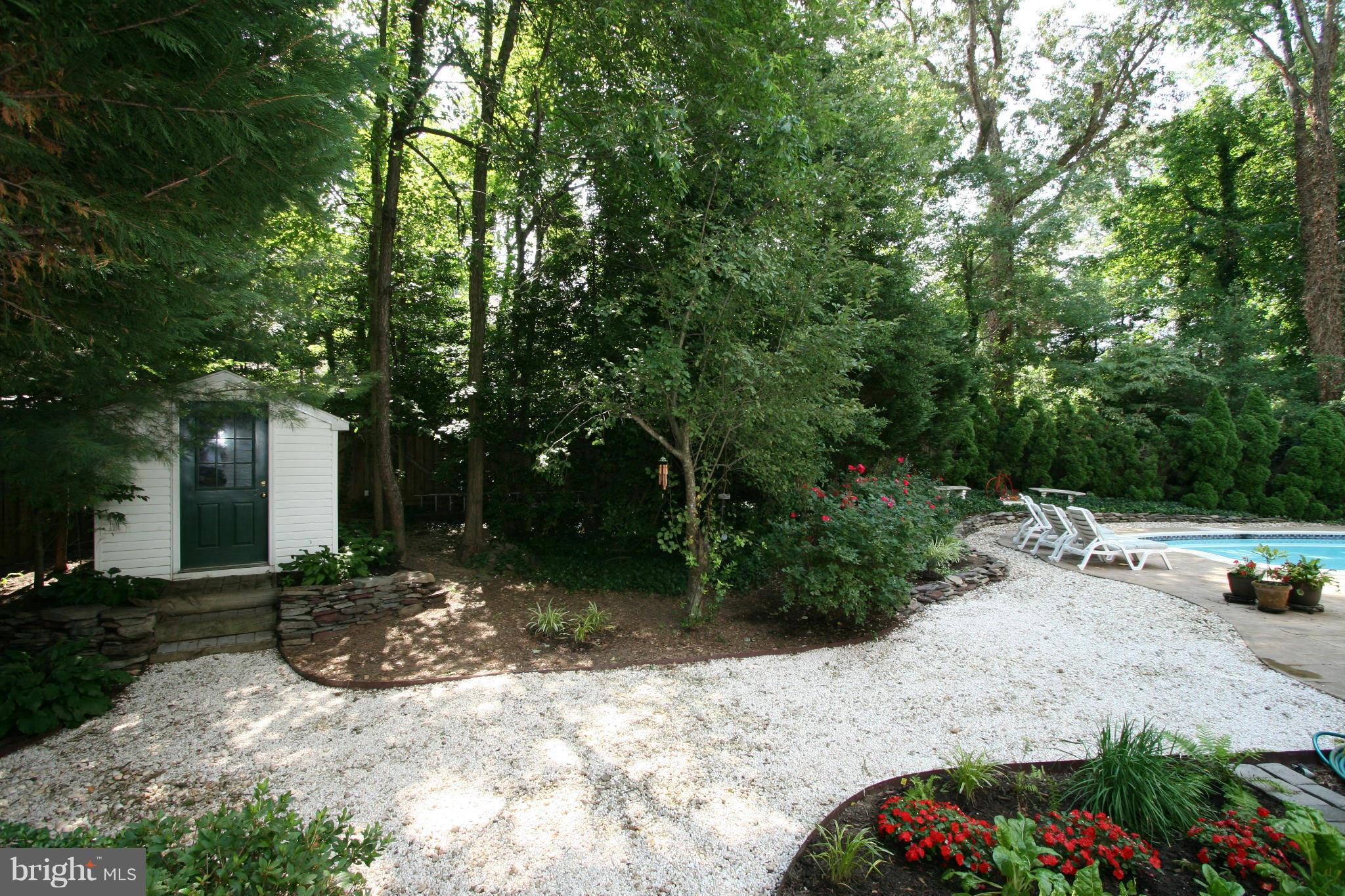 11939 Riders Lane Reston, VA 20191 - Photo 24 of 30 a view of a patio with table and chairs under an umbrella