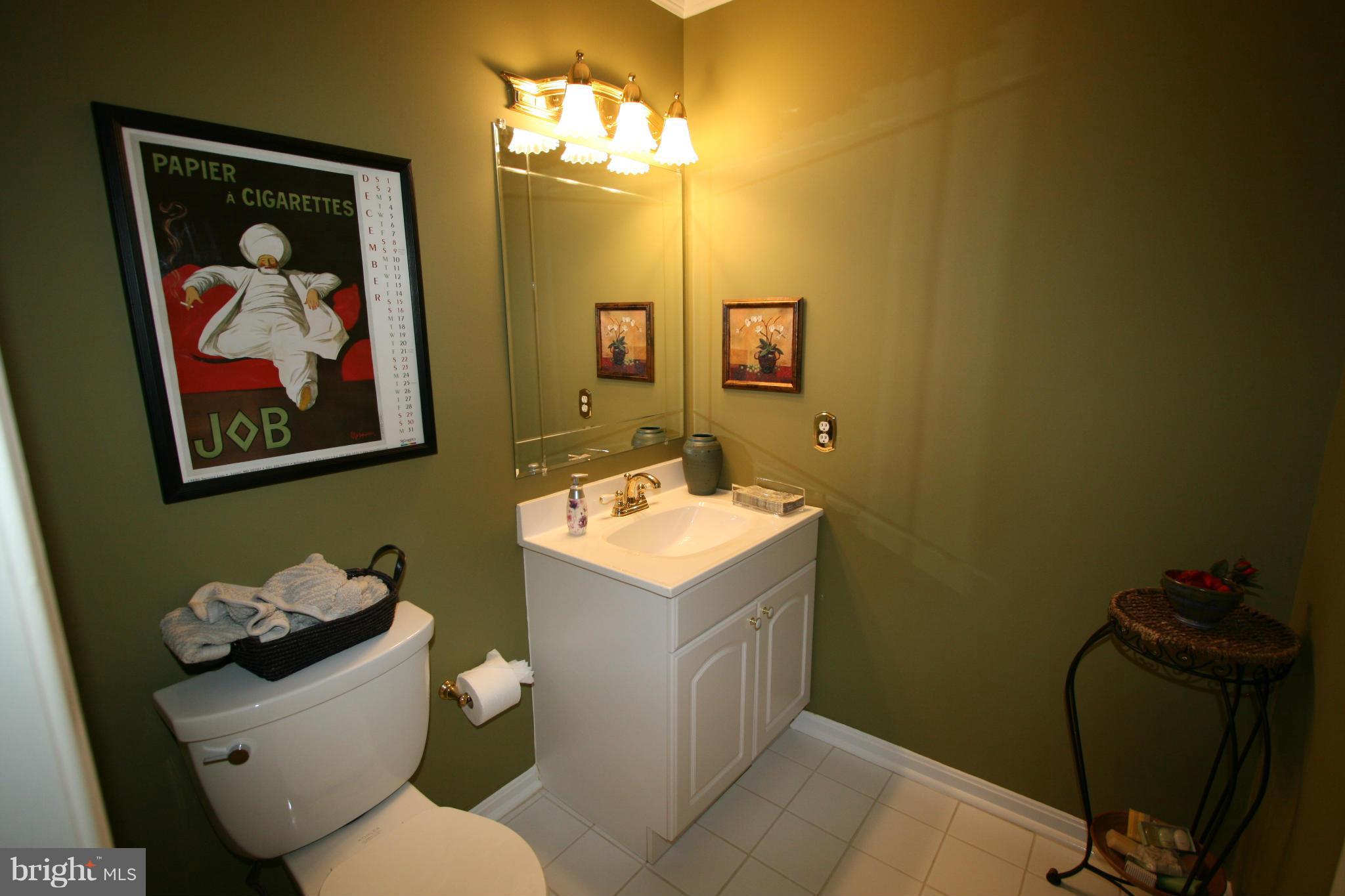 11939 Riders Lane Reston, VA 20191 - Photo 30 of 30 a bathroom with a toilet sink and mirror