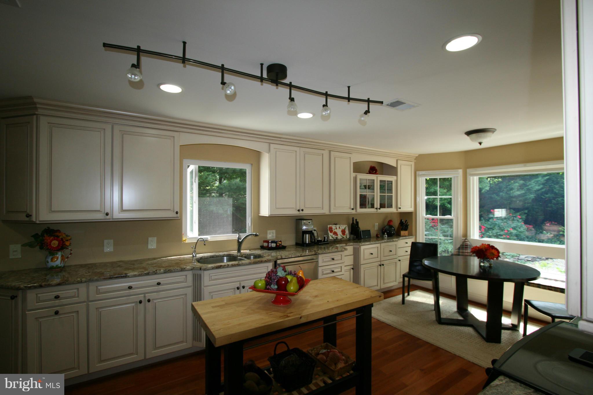 11939 Riders Lane Reston, VA 20191 - Photo 5 of 30 a kitchen with sink cabinets and dining table