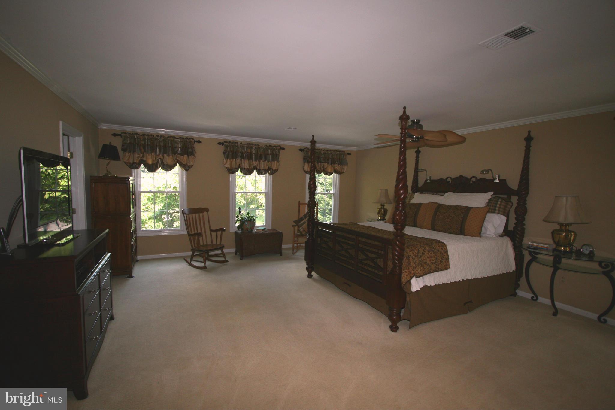 11939 Riders Lane Reston, VA 20191 - Photo 9 of 30 a bed room with furniture and a lamp