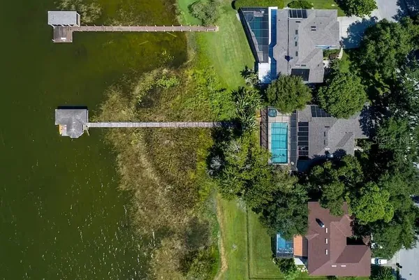 an aerial view of a house with a yard