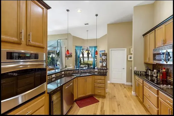 a kitchen with stainless steel appliances a sink stove and refrigerator