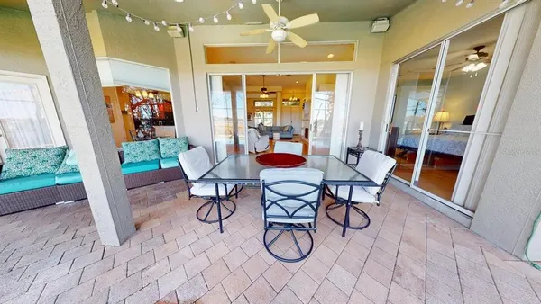 a dining room with furniture wooden floor and a chandelier