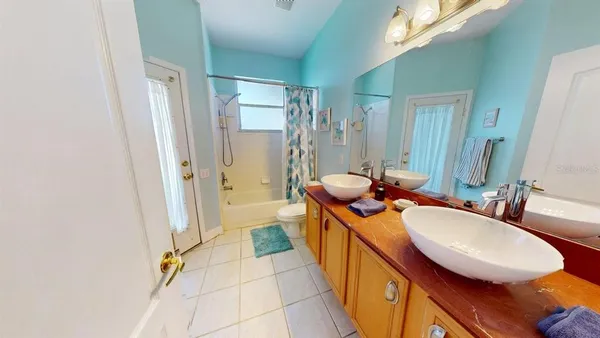 a bathroom with a sink a mirror a bathtub and shower