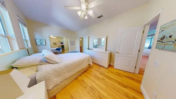 a bedroom with a bed and a chandelier