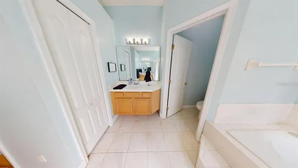 a bathroom with a sink a bath tub and a window