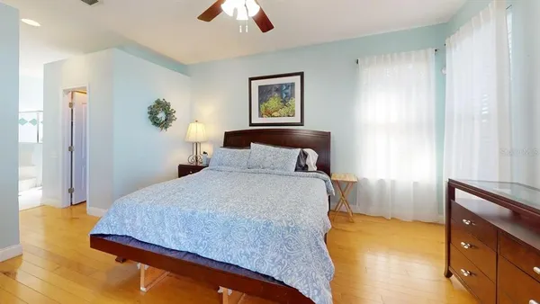 a bedroom with a bed and a chandelier