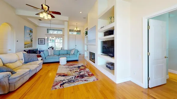 a living room with furniture fireplace and a chandelier