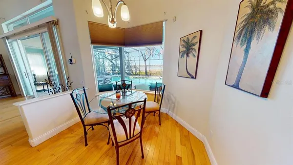 a view of a dining room with furniture and wooden floor